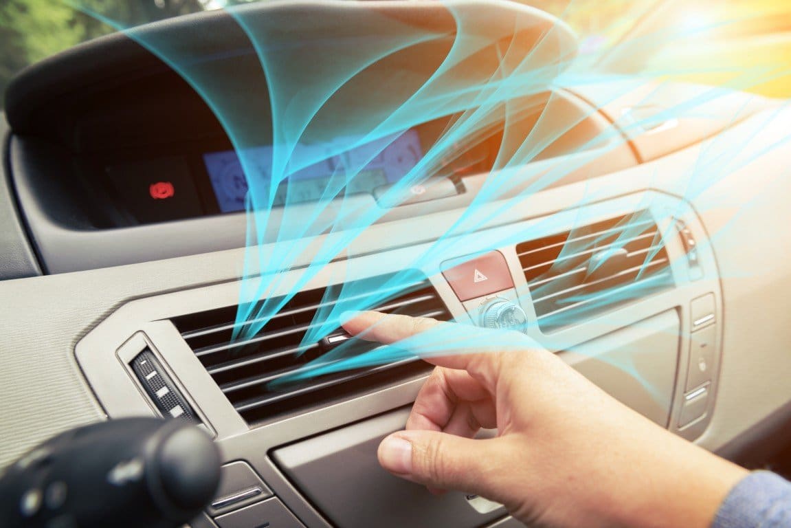 Cool air flowing from a car's dashboard vents on a sunny day
