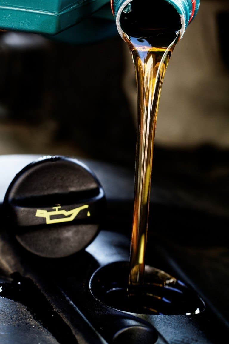 Fresh engine oil being poured into an engine